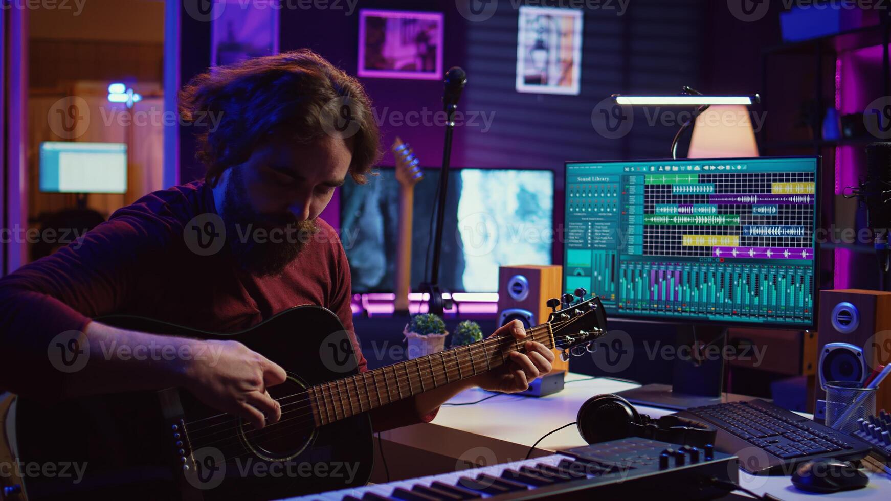 Skilled musician teaching how to play acoustic guitar online, creating internet tutorial to give assistance with musical instrument. Artist songwriter explaining accords and notes strings. Camera B. photo