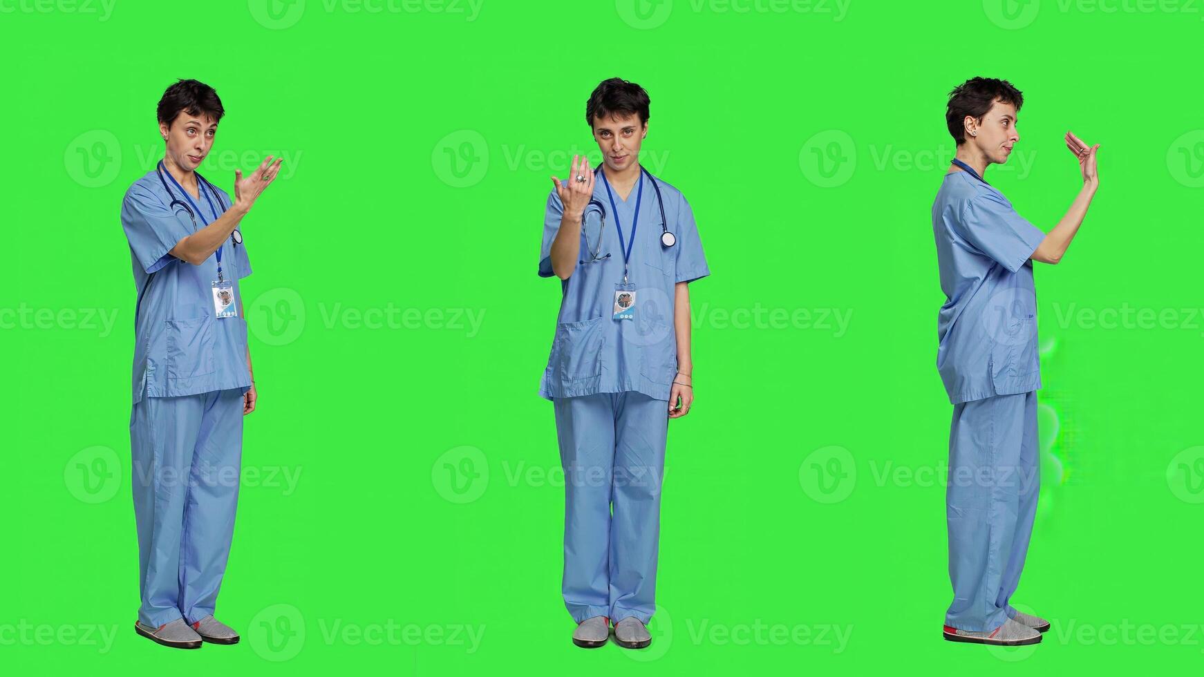 Medical assistant asking a person to come over closer against greenscreen backdrop, inviting patient to approach. Nurse in scrubs calling someone at checkup examination, young surgeon. Camera A. photo