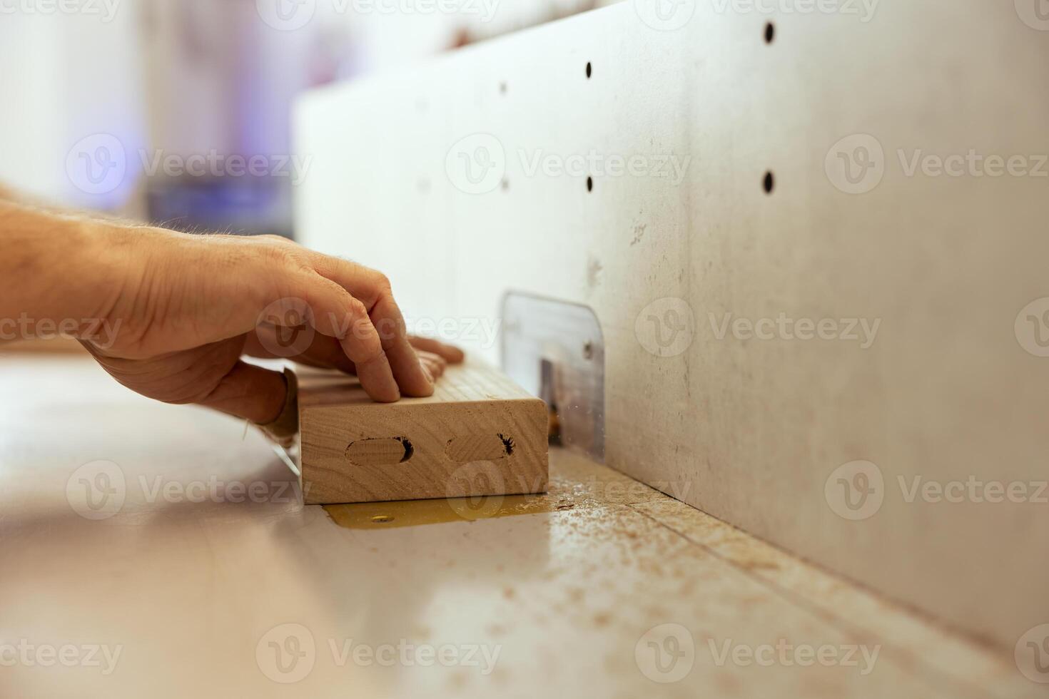 Woodworker using edge jointer in assembly studio for precision cutting of plank, making wooden objects, close up shot. Focus on wood shaper used by carpenter for smoothing out panels photo