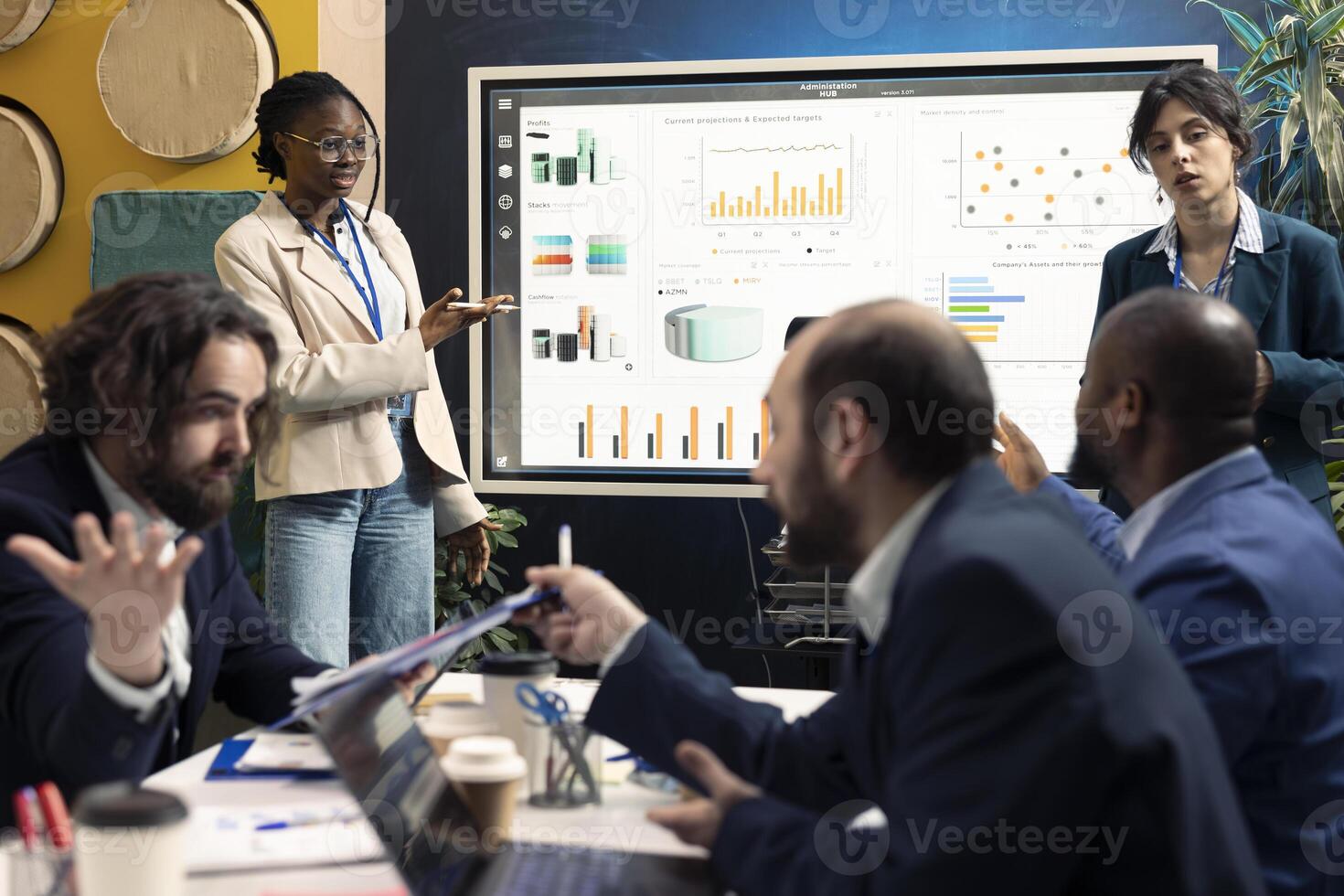 Team of enterprise workers preparing their pitch for the stakeholders meeting, working on ways to obtain more capital. Employees attend a conference to address financial potential. photo