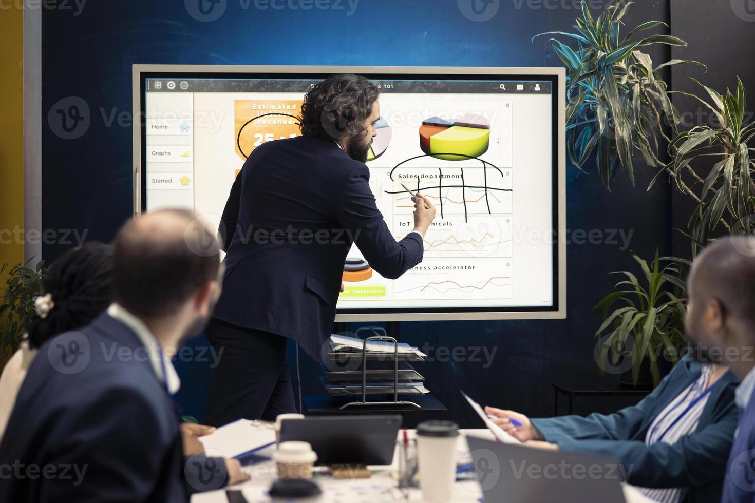 Enterprise manager works on creating business strategies and goals, studying market dynamics and customer feedback shown on interactive board. Corporation team attends a development meeting. photo