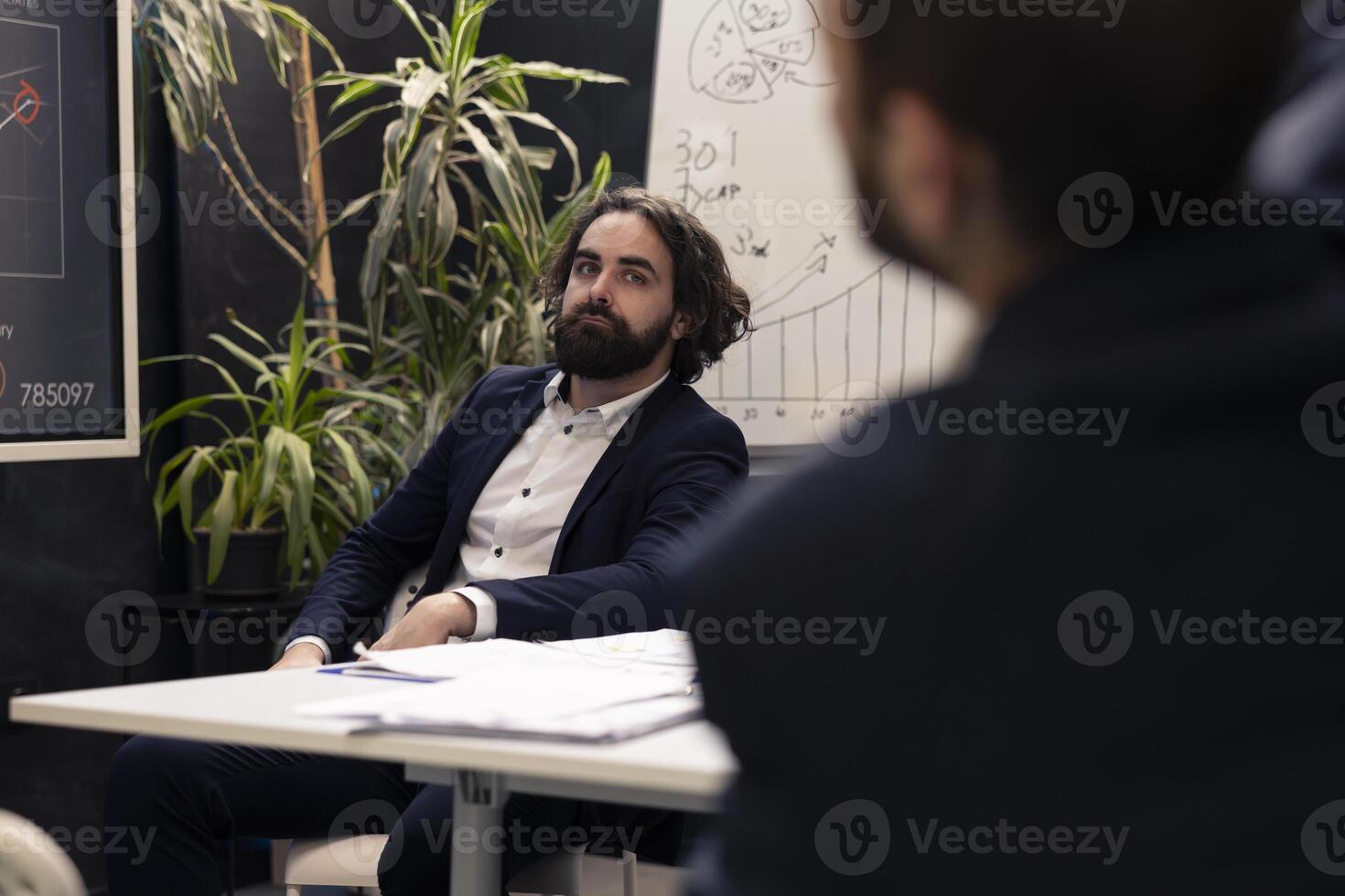 Business analyst listening to a pitch presentation with data reports to evaluate infographics and understand what can be improved, problem solving conference. Specialist identifying issues. photo