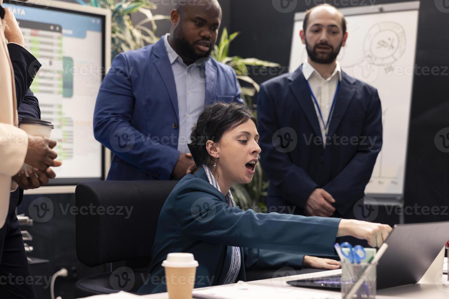 Displeased angry supervisor analyzing team progress and efficiency, crazy manager screaming at her staff members and being irritated with their workflow. Disappointed business woman. photo
