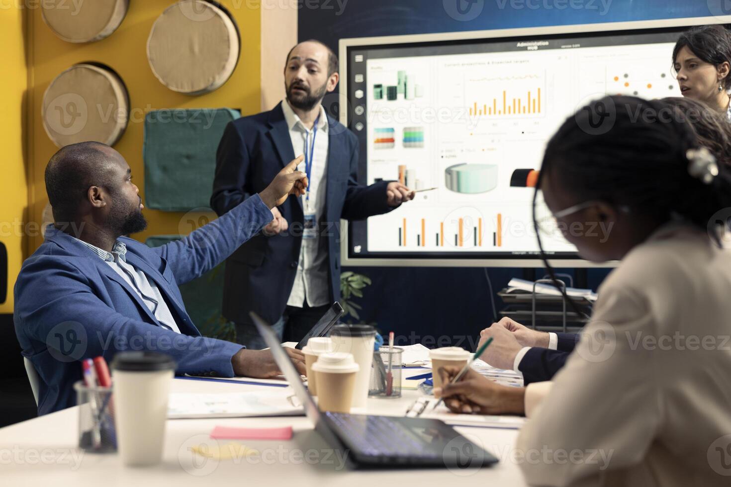 Business affiliates meeting to share insight and exchange opinions about infographics and statistics extracted from online research. Team collaborating on organizational development plan. photo