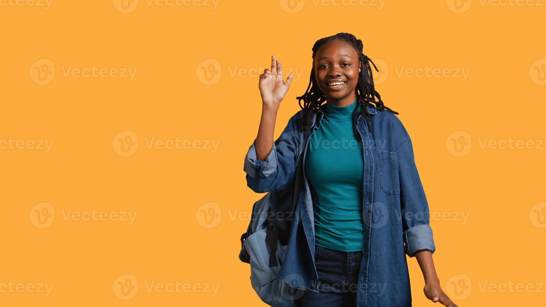 Enthusiastic african american student raising hand up to answer question, excited to tell teacher explanation to question in class, isolated over studio background, camera B photo
