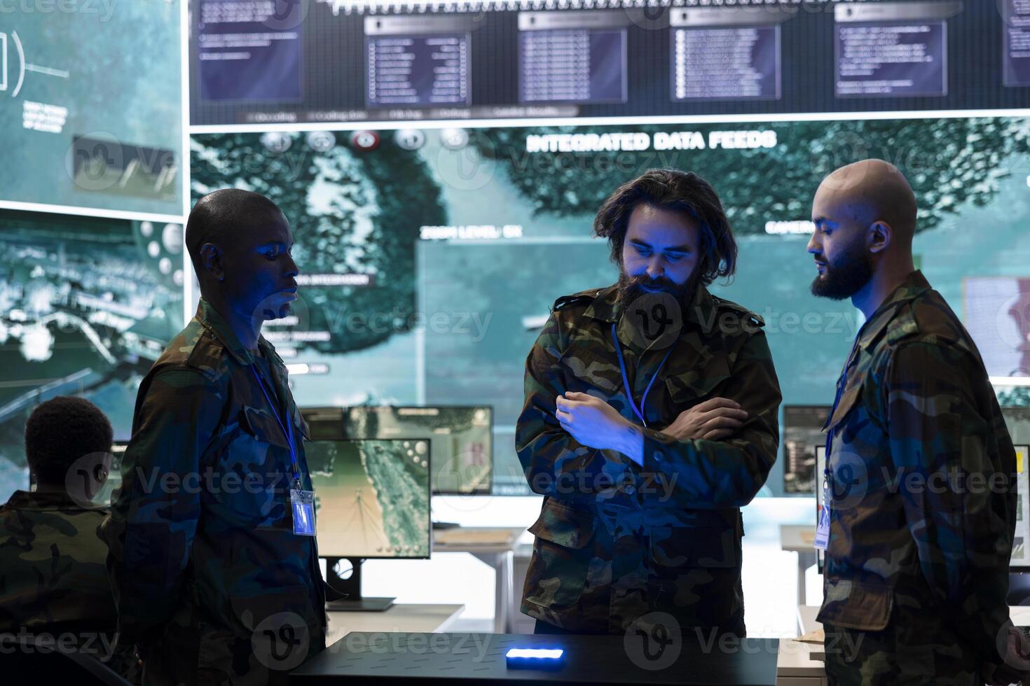 Diverse soldiers analyzing satellite images on a 3d hologram to discuss operations plan in command post, operating with high tech gear. Recruits using 3d projection for new defense mission. photo