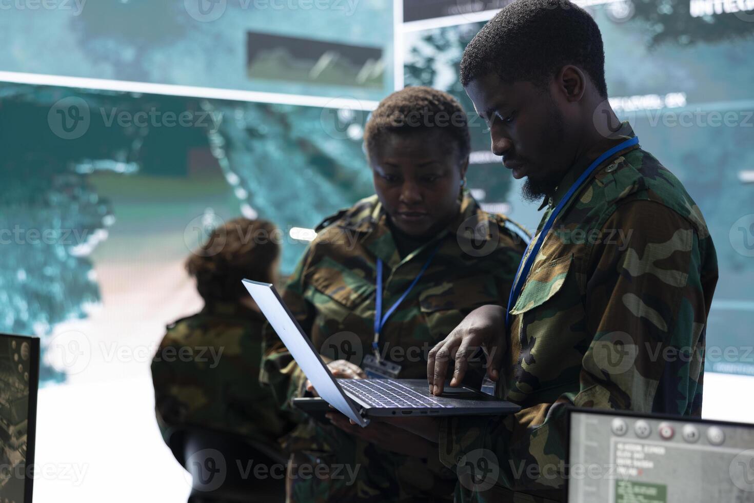 Team of army conscripts collecting important information from military radar surveillance system, working in command room power base of operations. National safety operations. photo