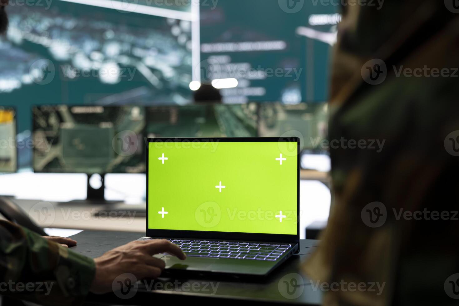 Trooper monitors chroma key mockup display on a laptop in general headquarters, providing real time information for national safety. High ranking recruit uses pc with copy space screen. photo