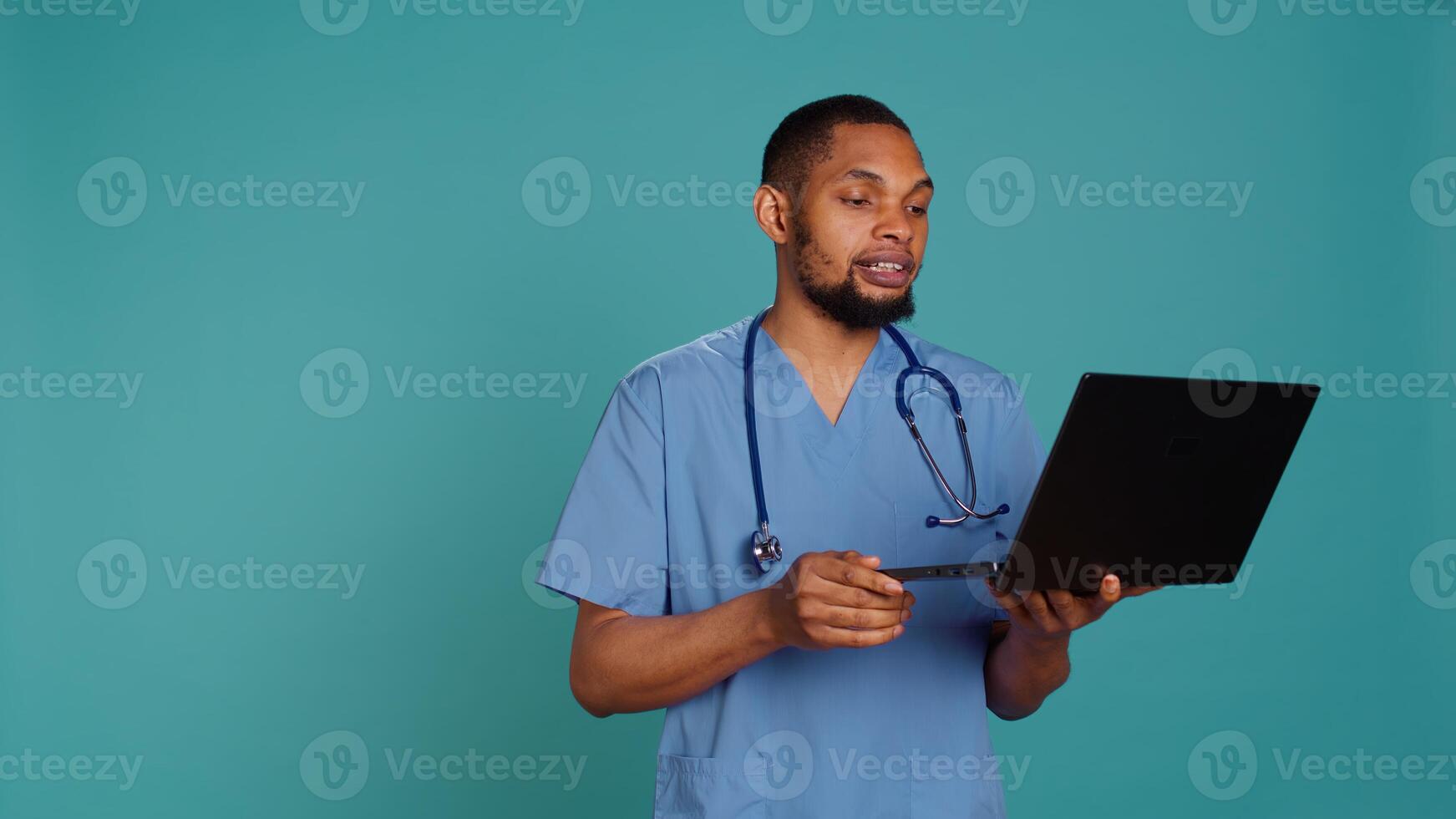 Practitioner in videocall meeting using laptop, greeting people. Healthcare expert in online telemedicine call with patients on notebook, isolated over studio background, camera B photo