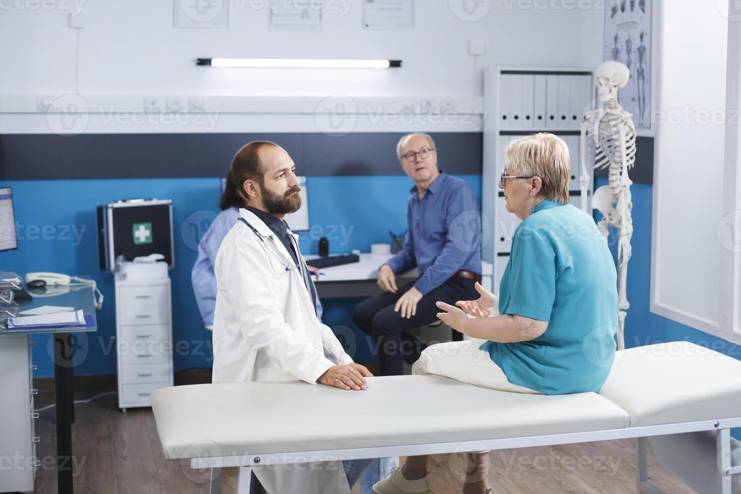 Elder woman consults with chiropractor for back pain. Senior patient receives medical help and therapy for physical recovery. The hospital offers physiotherapy exercises and rehabilitation. photo