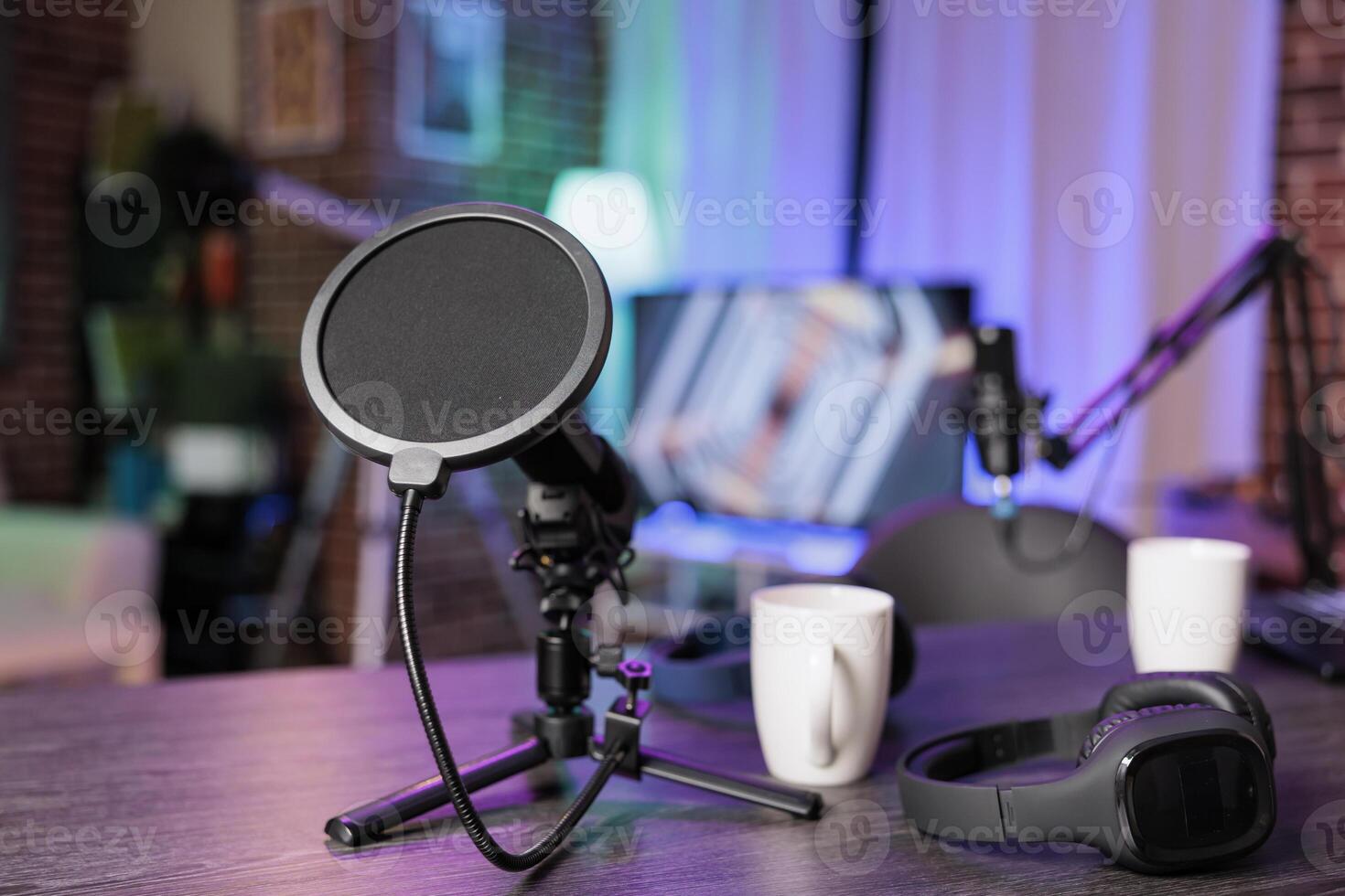Close up shot of podcast microphone used to record discussions for online livestreaming channel. Streaming sound capturing and recording technology in empty living room with neon lights photo