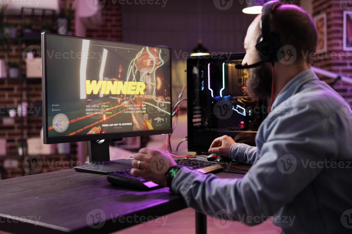 Gamer winning intense singleplayer spaceship arcade racing videogame on powerful gaming computer system with neon lights. Man feeling relaxed after finally passing difficult game level photo