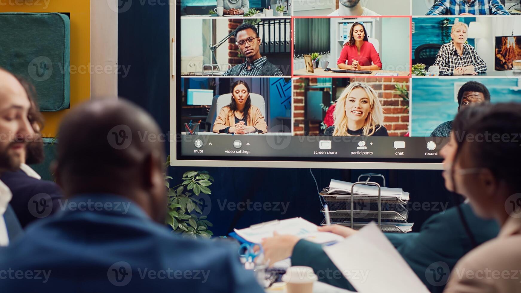 Business associates meeting with stakeholders on a videocall connection, sharing insight and updates on a new development project. Executive board members discussing about firm growth. Camera A. photo