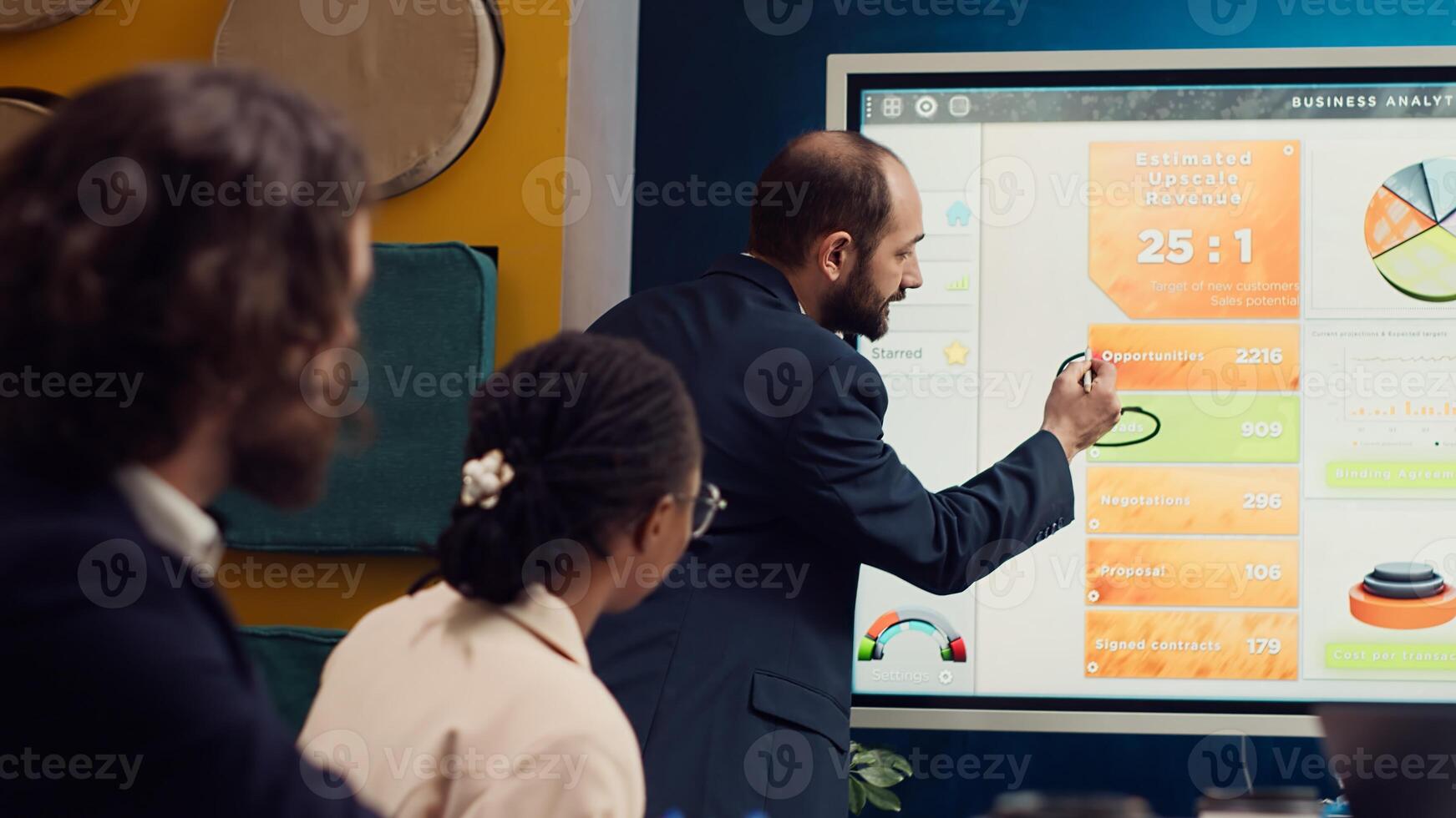 Sales manager creates a presentation to pitch in a new strategy for development, using interactive board to make his staff members understand the objectives. Business planning meeting. Camera A. photo