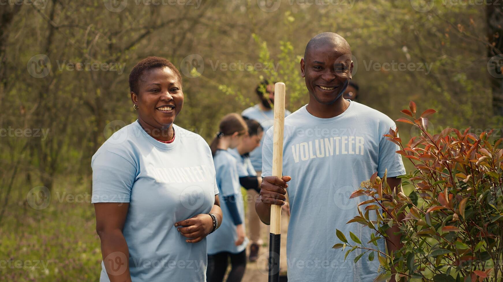 Portrait of a couple volunteering to plant trees and collect trash from the woods, hold shovel and showing devotion for ecological justice. Environment activists fight nature conservation. Camera A. photo