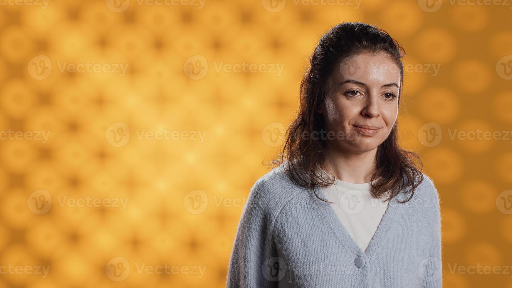 Cheerful woman happily doing salutation hand gesture, feeling optimistic. Portrait of joyous caucasian person raising arm to greet someone, gesturing, isolated over studio background, camera A photo