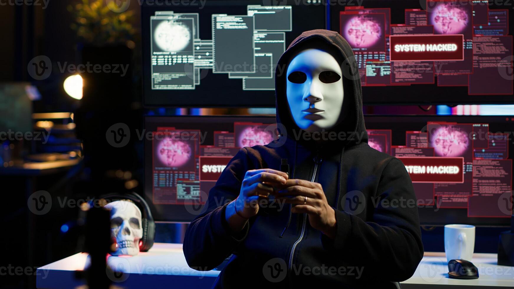 Hacker group member wearing anonymous mask filming threatening another country government to steal military secrets, doing international espionage in hidden underground base, camera A photo