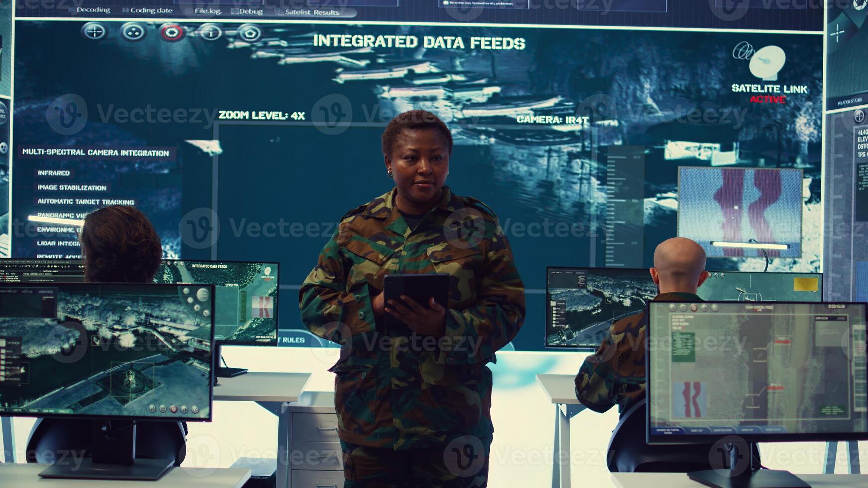 Woman sergeant major working on deployment of electronic warfare tools to disrupt enemy communications. Female army soldier with camouflage uniform operating on high tech gear. Camera B. photo