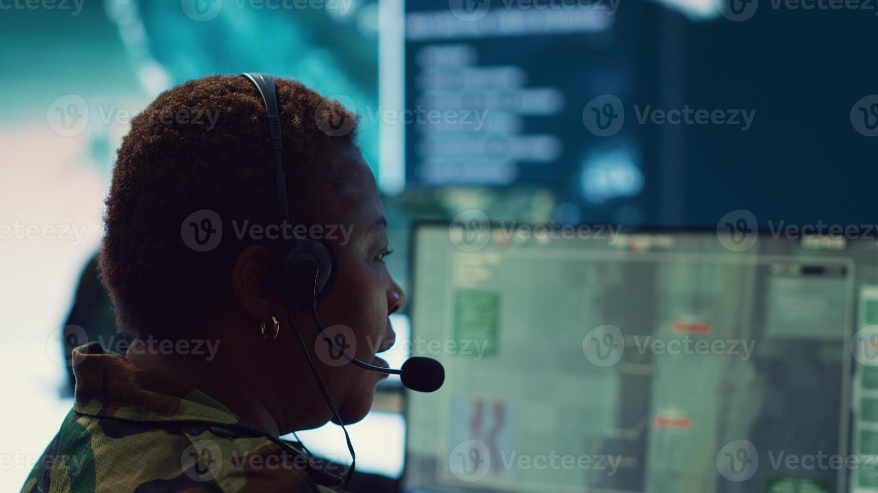 Woman army officer operates on gps surveillance footage to gather crucial information about enemy plans. Operator examines a satellite world map to provide support to field troops. Camera A. photo