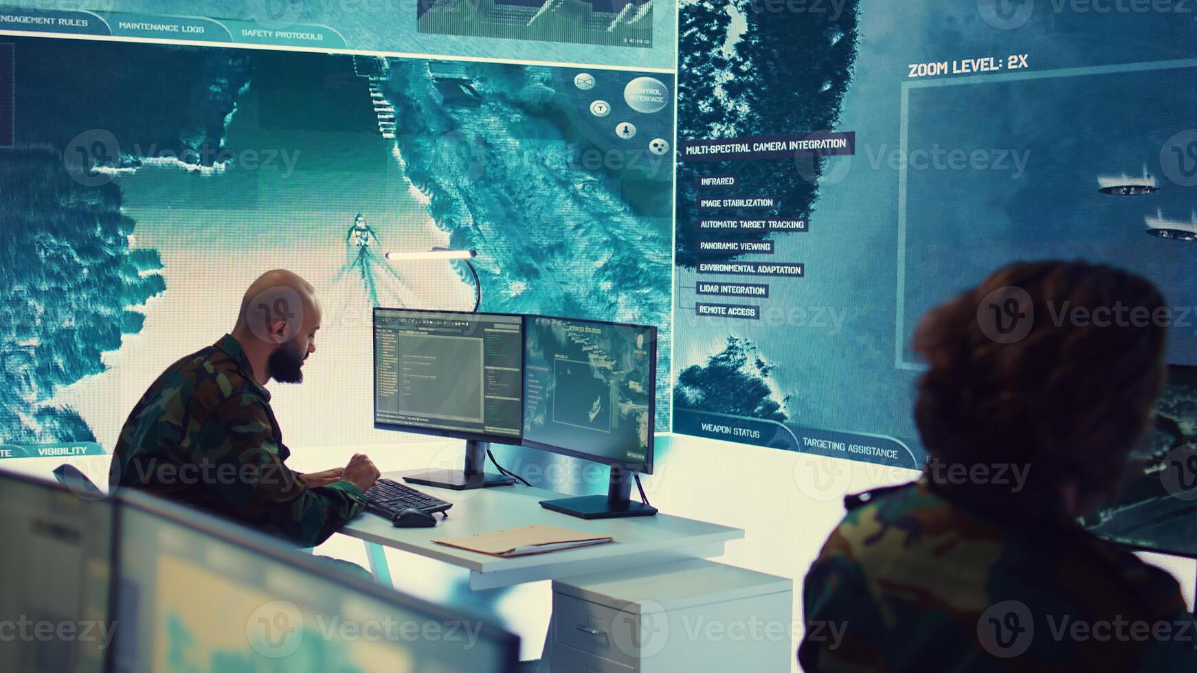 Woman army officer coordinating special operations mission in command post, monitoring surveillance satellite footage on big screen in military power base. Female soldier on duty. Camera B. photo