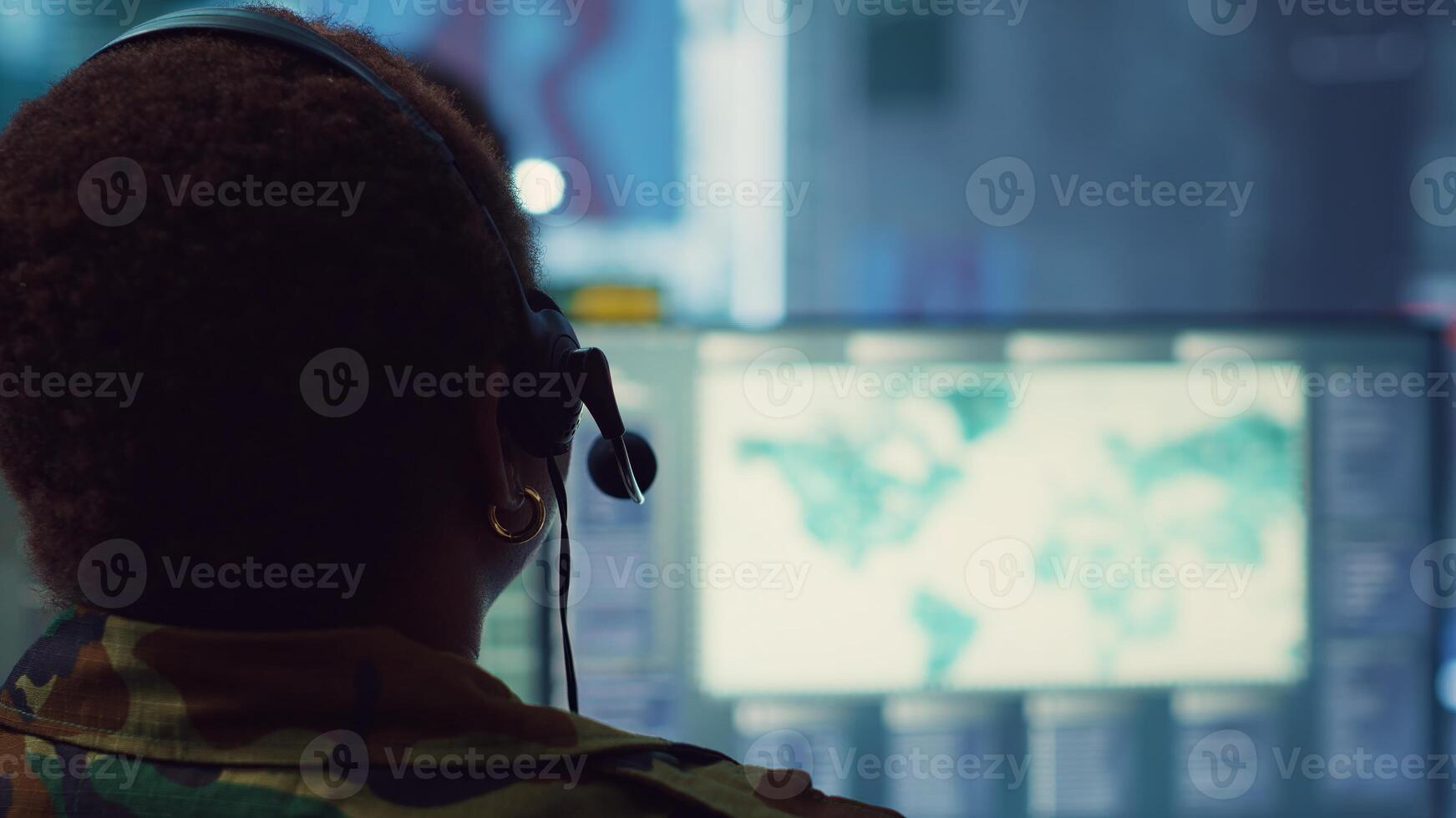 Woman military personnel tracking enemy vessels on the coast line territory, working on national safety and providing real time data to the dispatch center. Reconnaissance system. Camera A. photo