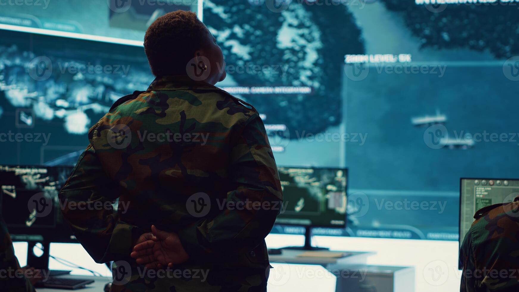 Female technical sergeant monitoring air traffic to detect any enemy aircraft, working in federal reconnaissance system to ensure national safety. Woman officer uses big screen and gear. Camera A. photo