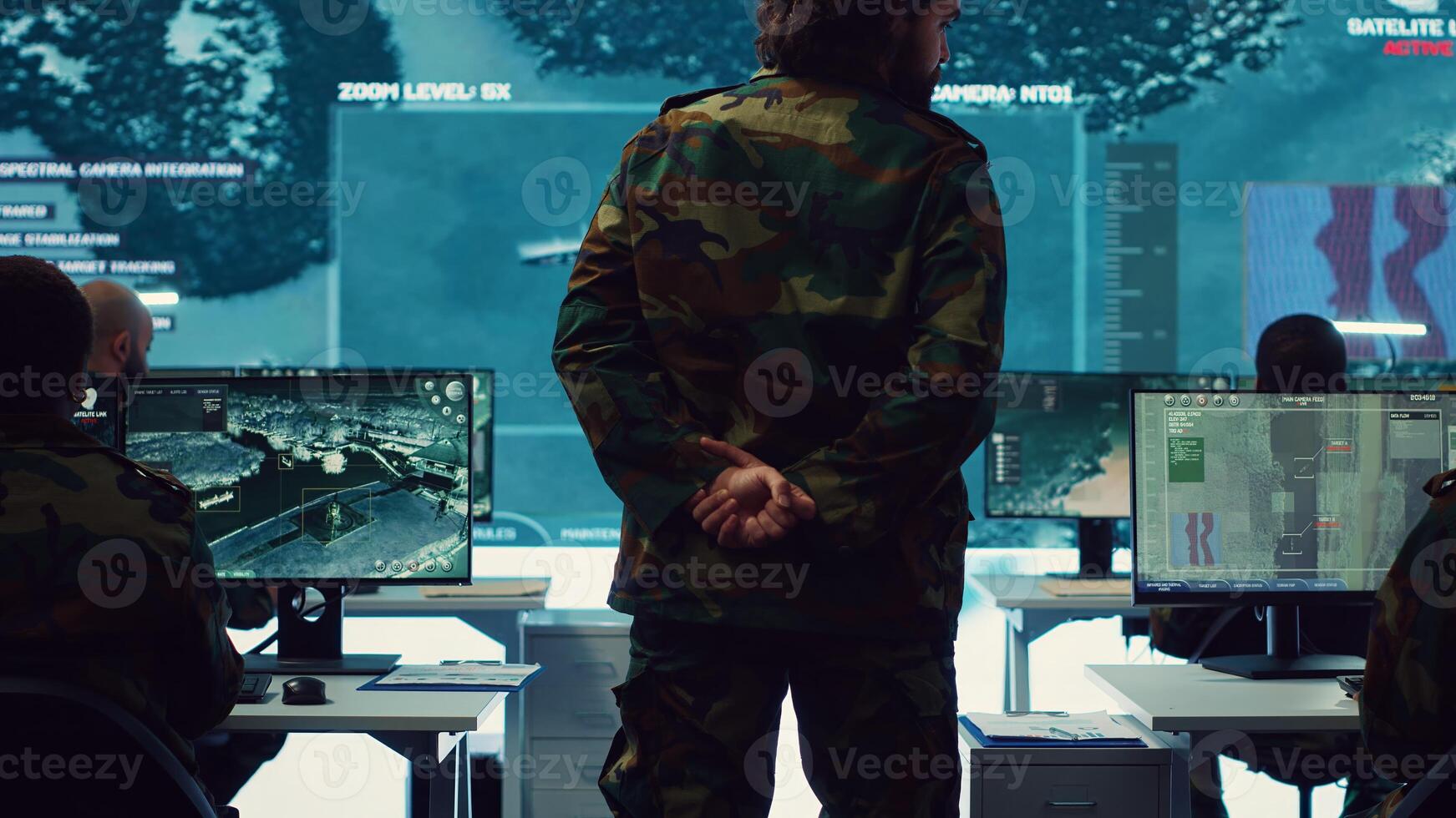 Colonel overseeing special operation to gather intelligence in control center with CCTV surveillance information on a big screen. Specialist targeting enemy military power base. Camera A. photo
