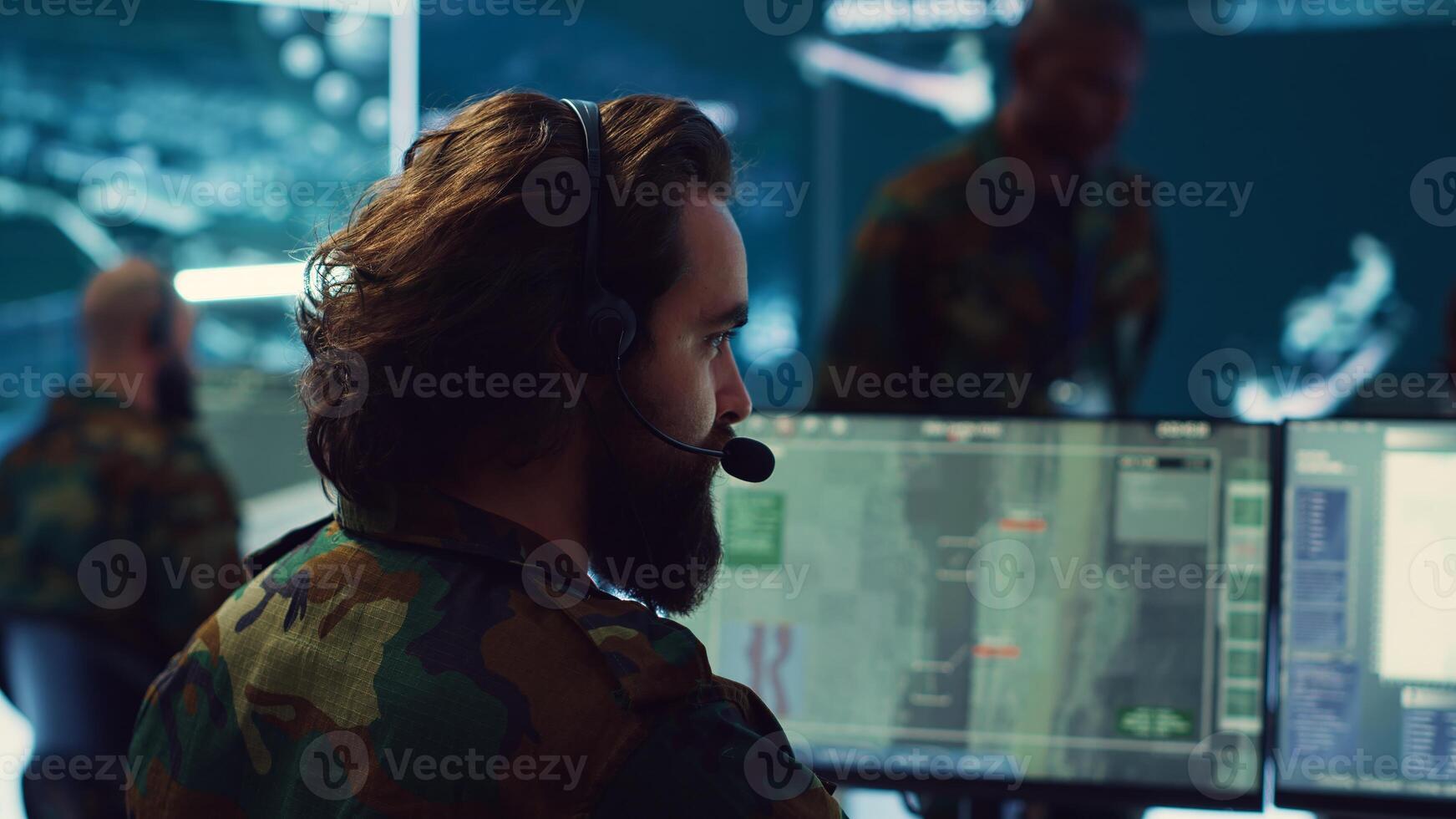 Reconnaissance department operator gathering information crucial for a national safety mission, transmitting intelligence to the troops. Telecommunications personnel in command post. Camera A. photo