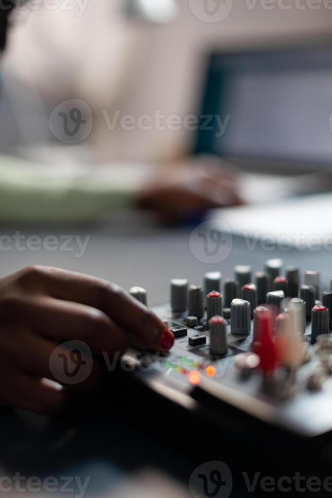 Closeup of vlogger woman checking sound of mixer while recording online vlog talking with subscribers using vlogging microphone. Content creator filming for social media. On air talk show photo