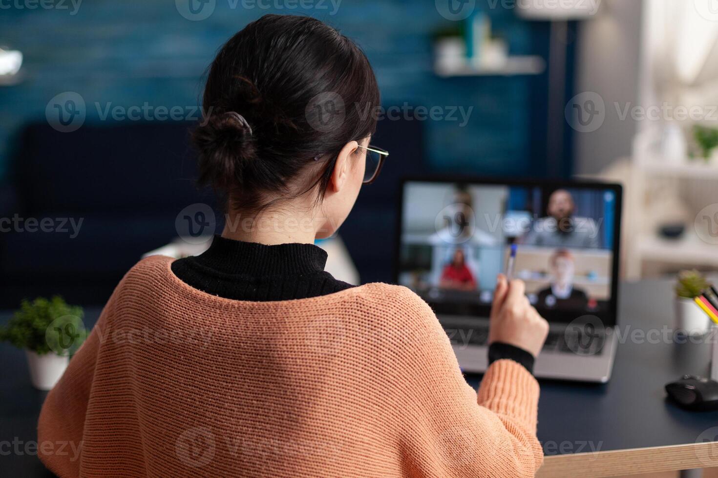 Student studying from home discussing with colleagues in webcam conference. Freelancer having group online meeting on laptop. Briefing videocall with team in remote office. photo