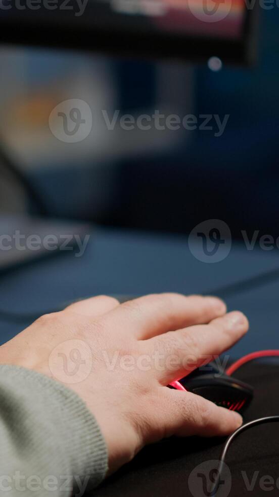 Close-up of man hands gamer playing game using RGB keyboard during virtual championship in cyberspace. Online streaming cyber performing on powerful personal computer during gaming tournament photo