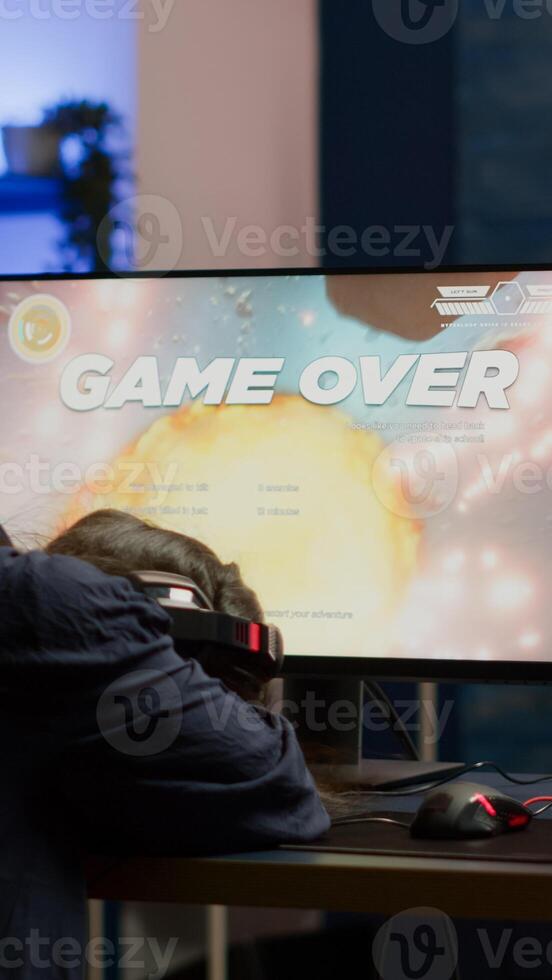 Angry pro woman gamer losing space shooter game during online championship. Cyber player testing virtual games using powerful personal computer in gaming room during esports tournament photo