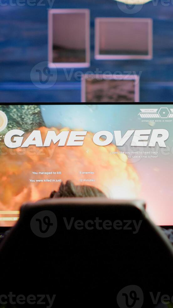Upset professional woman gamer wearing headset losing space shooter game in cybersport competition. Tired pro cyber player gaming online games on powerful personal computer with RGB lights. photo