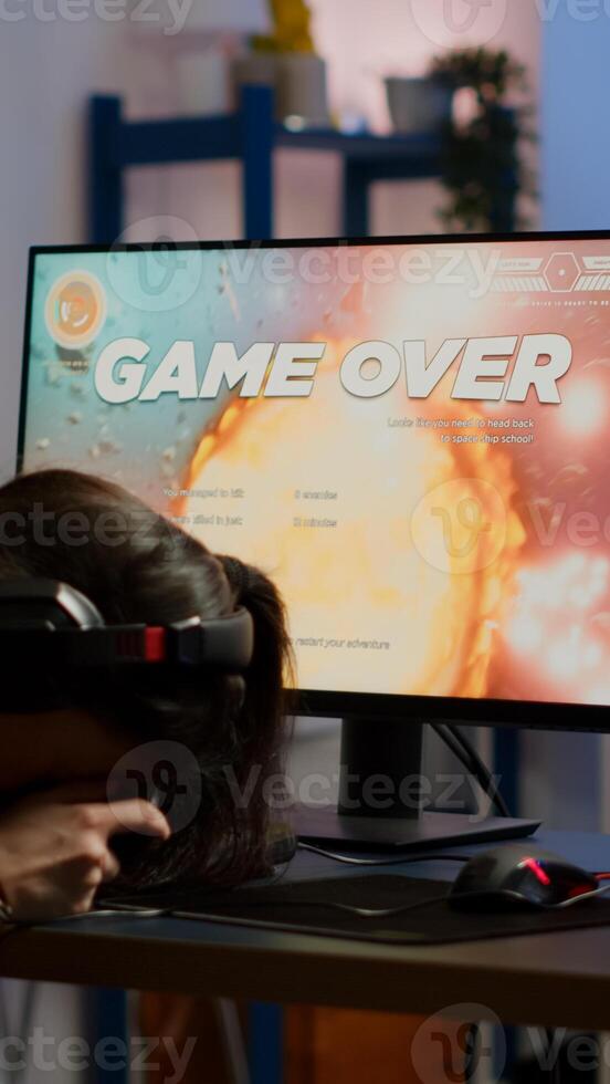 Pro woman gamer losing space shooter game competition on professional powerful computer with wireless controller. Professional player streaming online game using professional joystick and headset photo