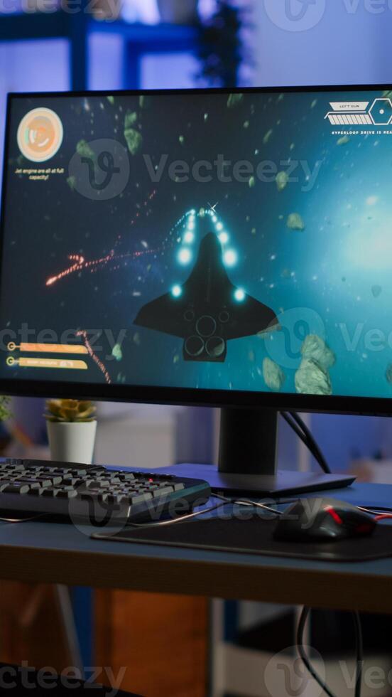 Addicted lady playing space shooter game using headphones ,wireless joystick and RGB powerful personal computer. Cyber gamer with headset and joypad performing virtual games at gaming championship photo