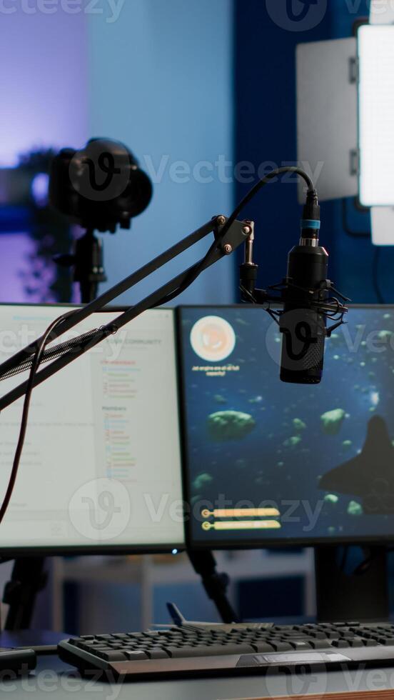 Empty gaming studio with RGB led lights powerful personal computer for streaming online competition. Display with stream chat prepared for virtual tournament, living room with nobody in photo