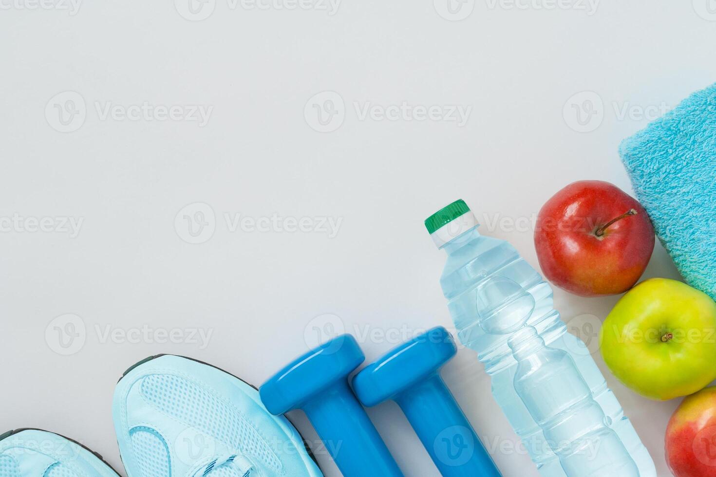 Attributes of a healthy lifestyle food, sports or athlete's equipment on bright background. Flat view with copy space. photo