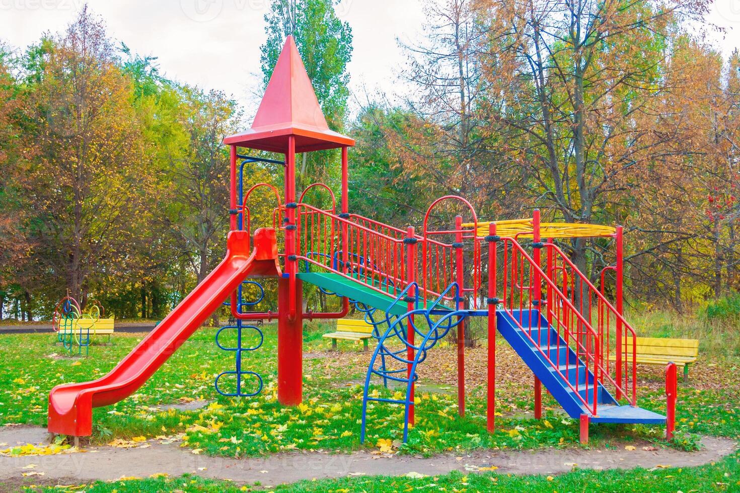 Colored children's playground from plastic in the park photo