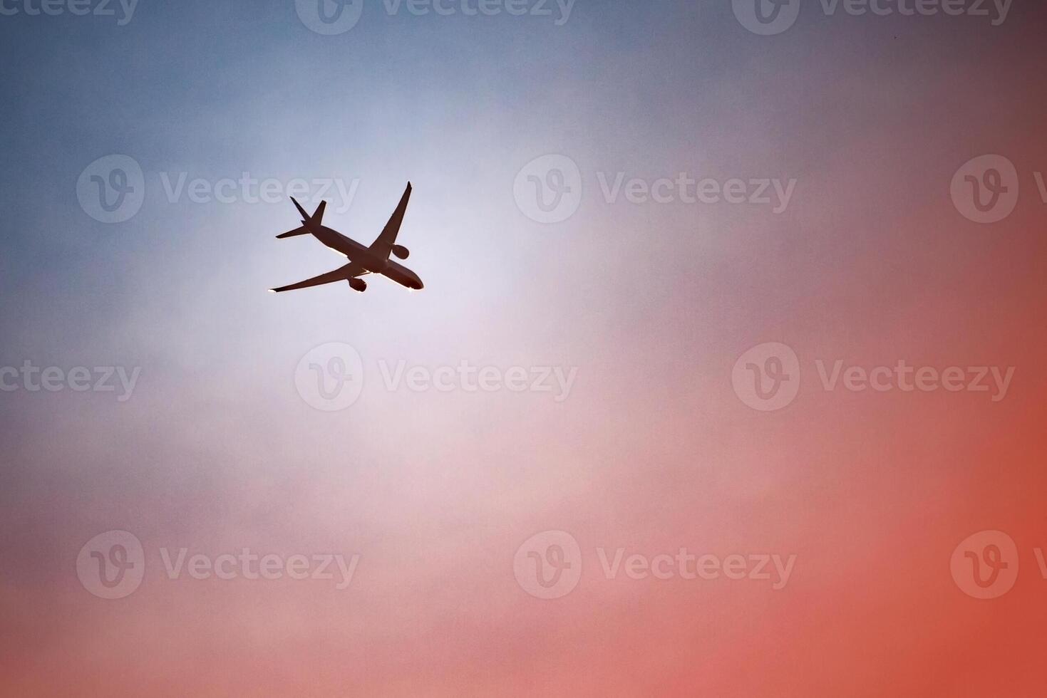 dark silhouette of an airplane in the dramatic evening sky photo