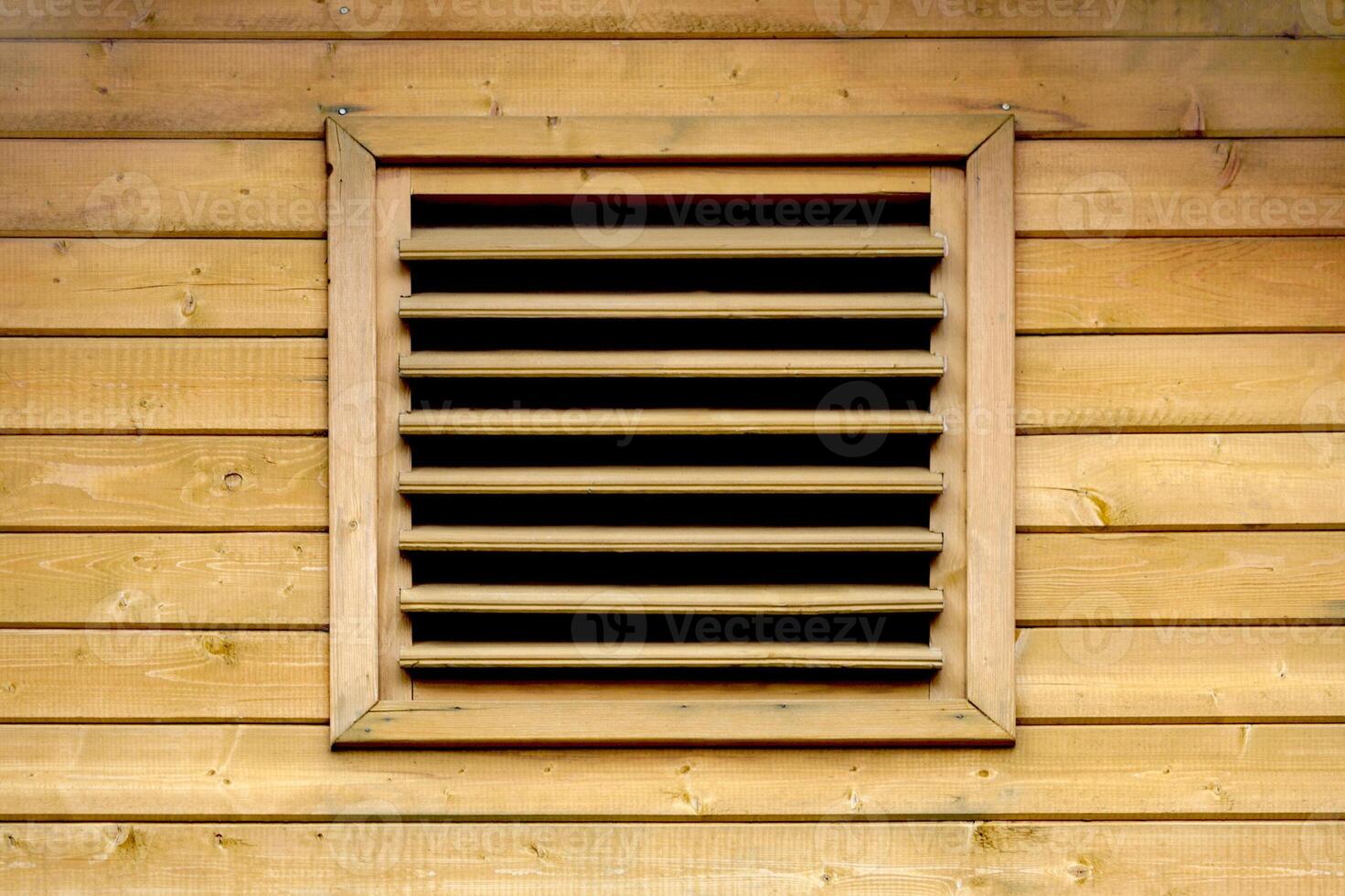 wooden ventilation grille on the facade of a wooden wall photo
