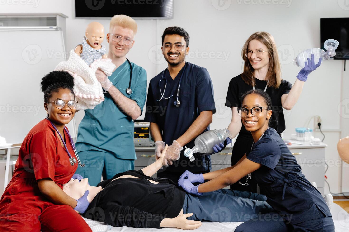 A group of medical students practice CPR on a mannequin during a training session photo