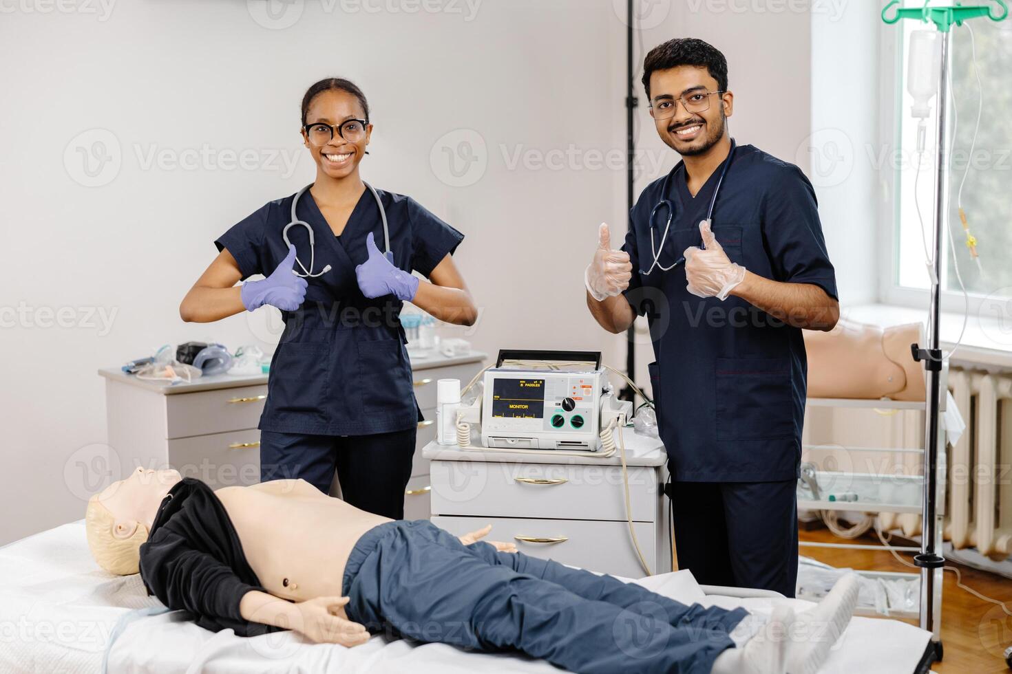 Two medical students practice CPR on a mannequin in a hospital room photo