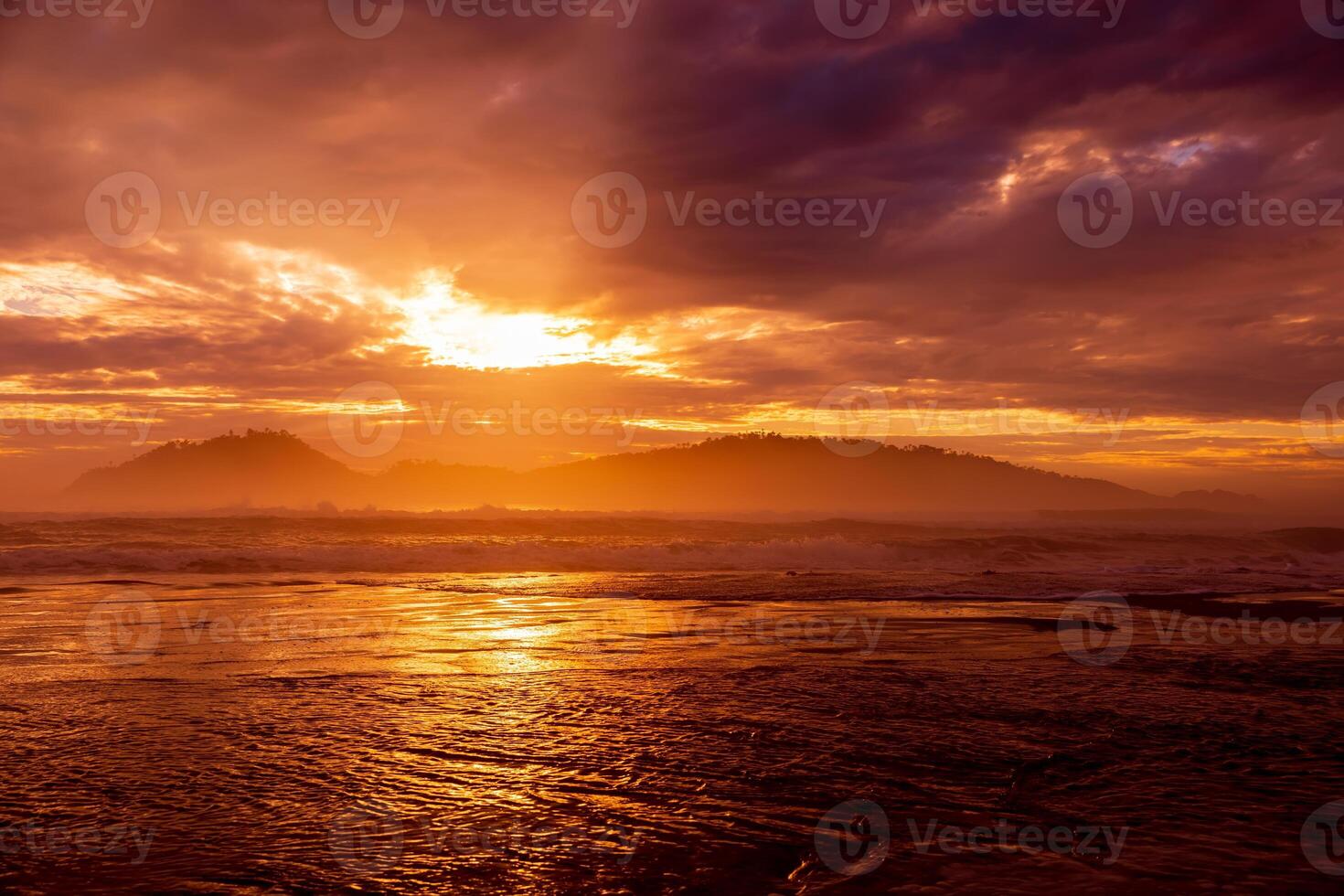 Warm sunrise with clouds and silhouette of Campeche island in Florianopolis, Brazil photo