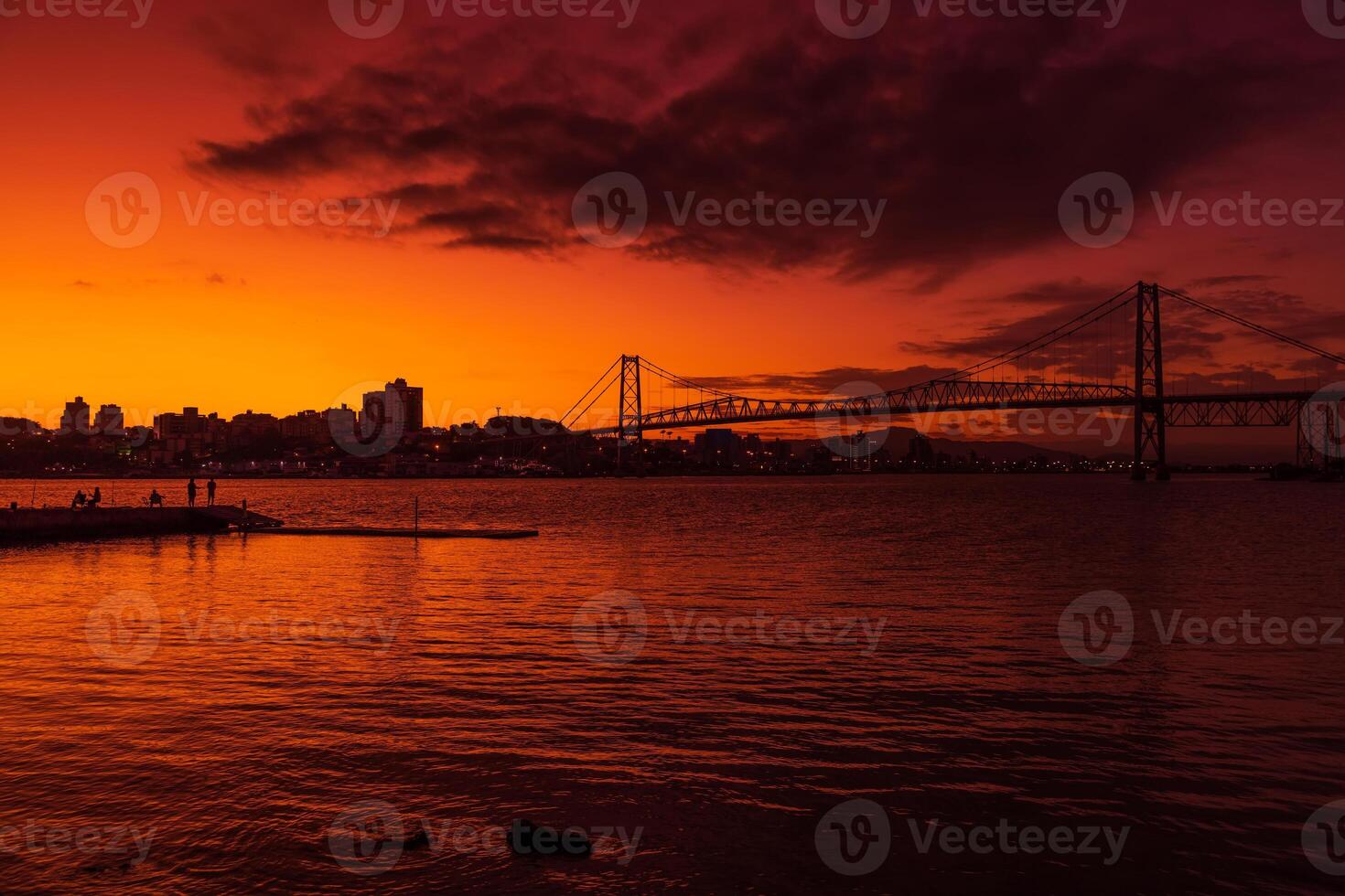 Hercilio luz cable bridge with sunset sky and reflection on water in Florianopolis photo