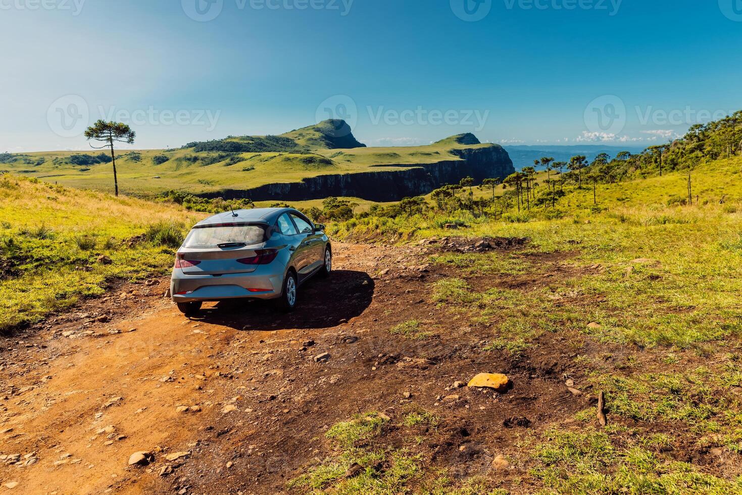 Traveling by car on dirt road in a scenic landscape near Espraiado canyon in Santa Catarina, Brazil. photo