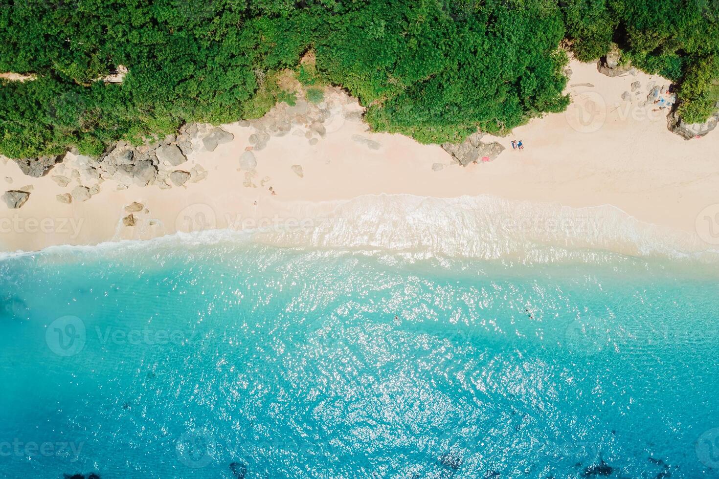 Paradise sandy beach with turquoise ocean in Bali. Aerial view photo
