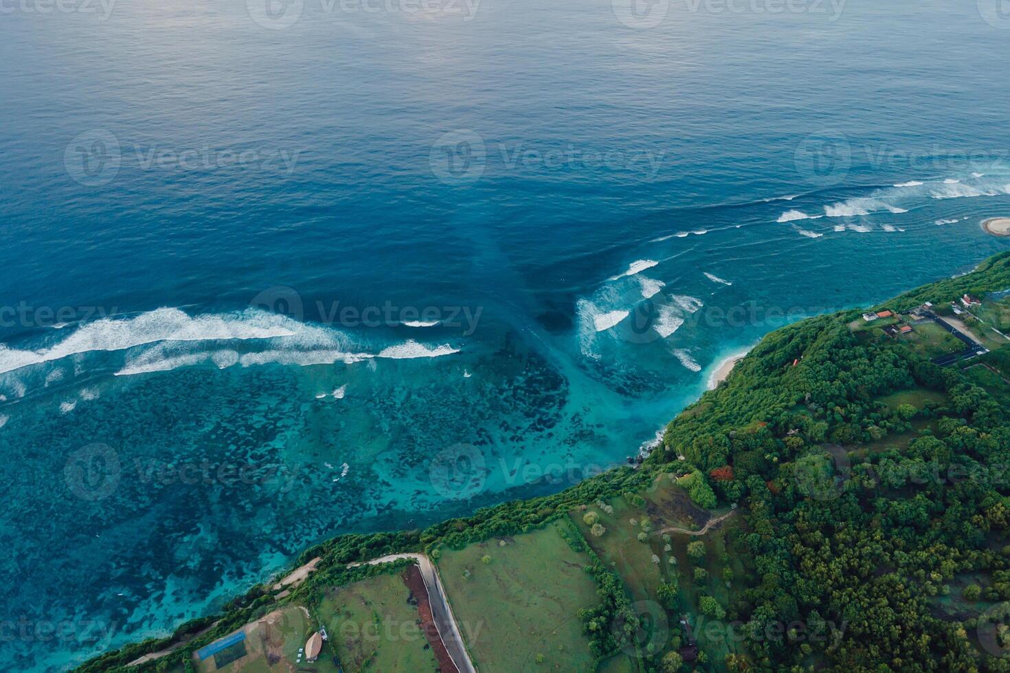 Drone view of coastline with ocean waves and current canal in Bali. Green bowl beach photo