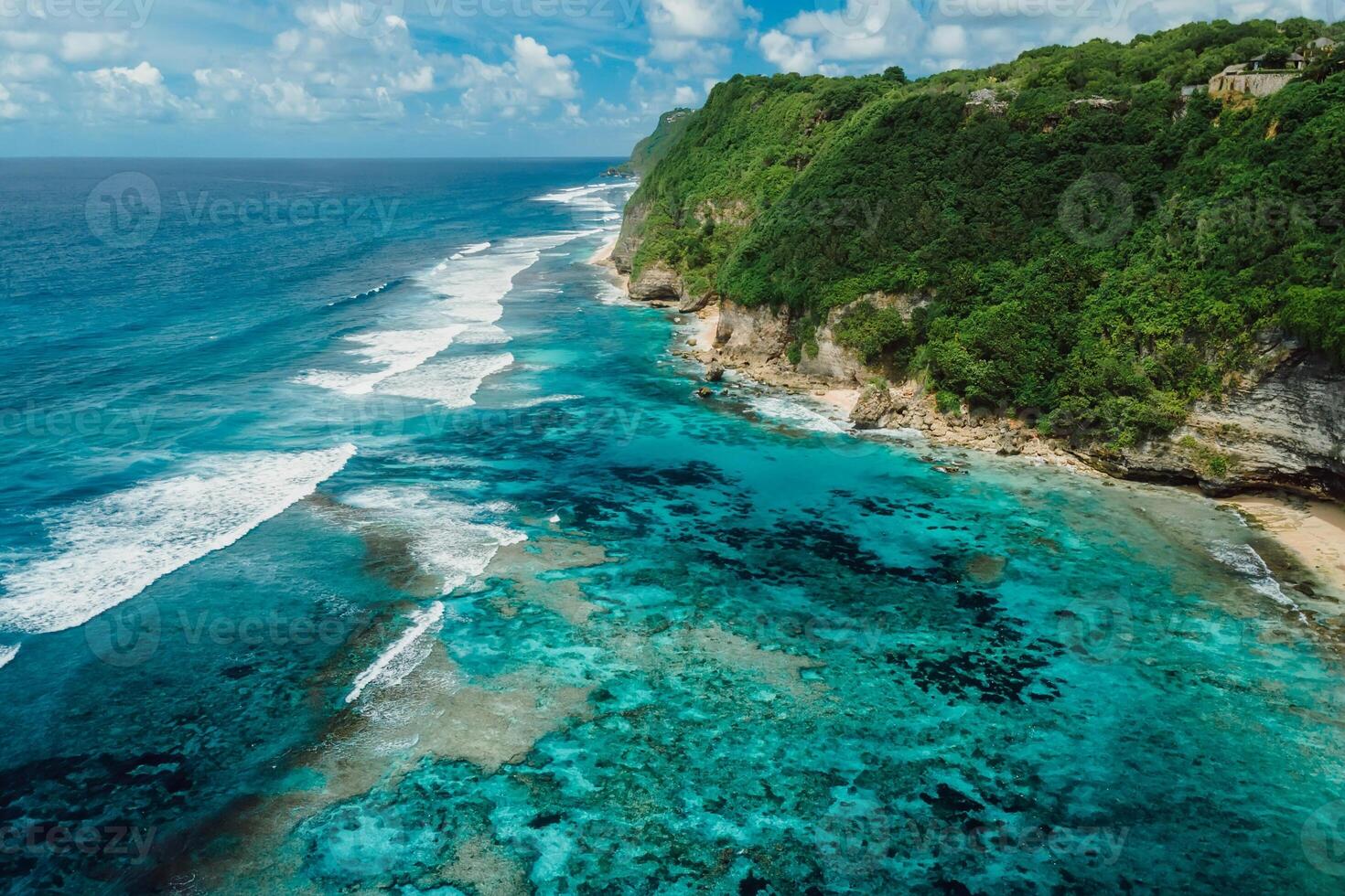 Coastline with turquoise ocean and green cliffs in Bali. Aerial view photo