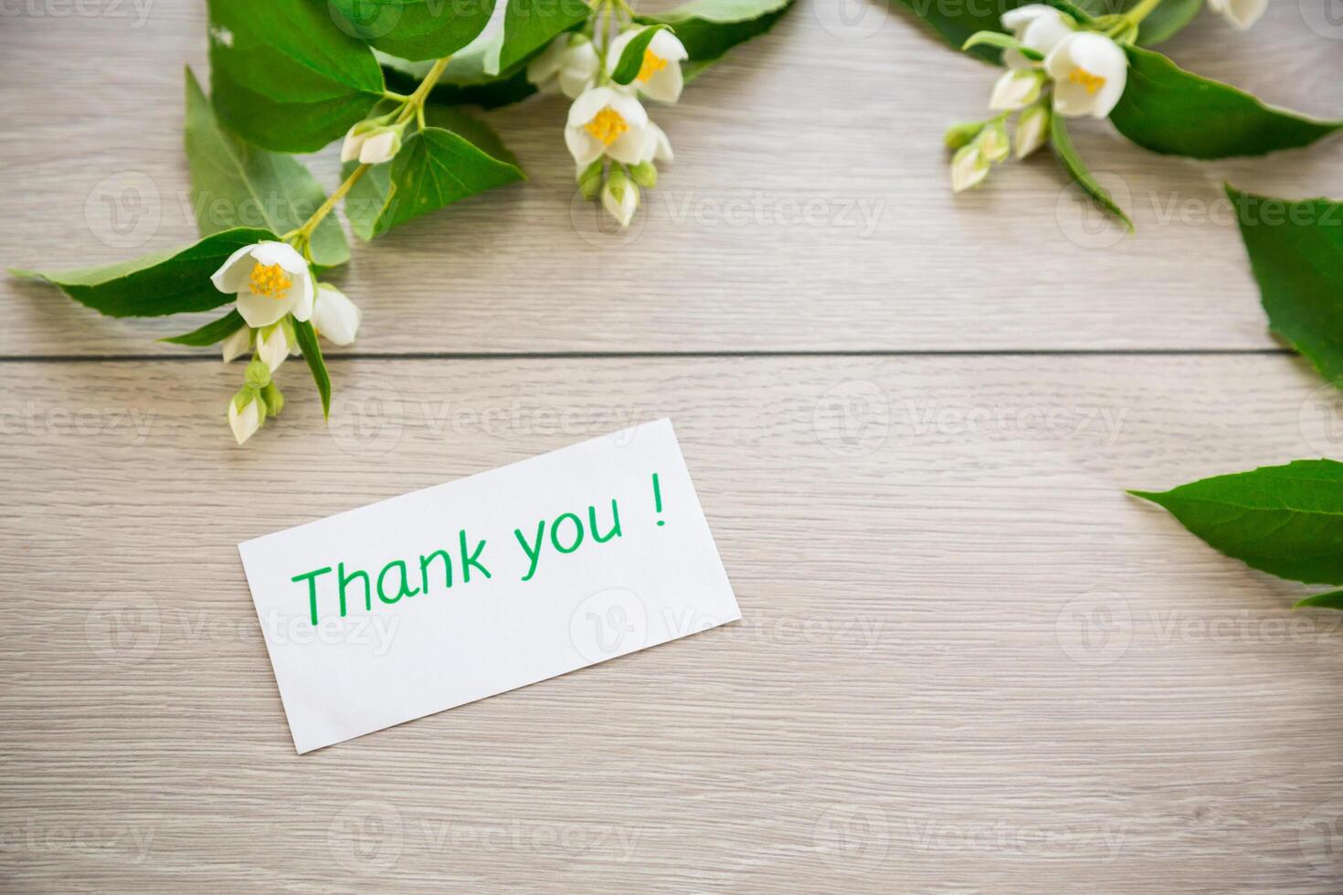wooden light background with white jasmine flowers photo