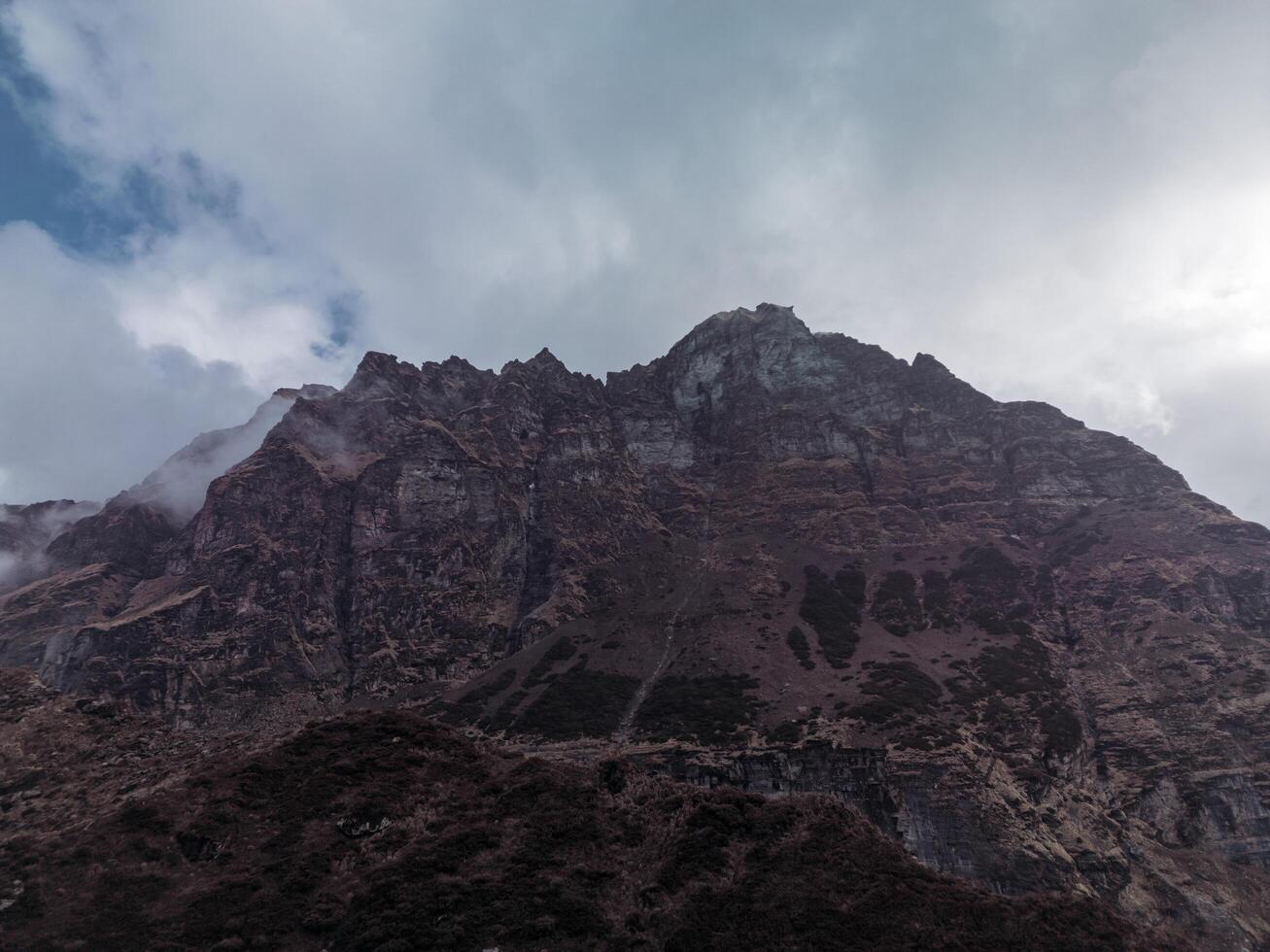 clouds over the mountains, mountains in the fog, during annapurna, annapurna base camp nepal photo